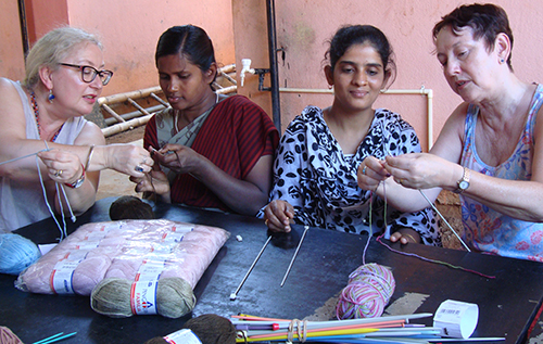 Girls being taught how to knit